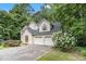 Attached two-car garage with white doors and lush landscaping at 3420 Cranborne, Marietta, GA 30062