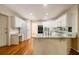 Kitchen featuring hardwood floors, white cabinets, a white refrigerator, an oven, and granite countertops at 3420 Cranborne, Marietta, GA 30062