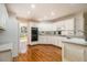 Kitchen featuring hardwood floors, white cabinets, a double oven, granite countertops, and stainless steel appliances at 3420 Cranborne, Marietta, GA 30062