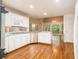 Kitchen featuring hardwood floors, white cabinets, stainless steel appliances, and views of the backyard at 3420 Cranborne, Marietta, GA 30062