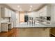 Kitchen featuring hardwood floors, white cabinets, a white refrigerator, an oven, and granite countertops at 3420 Cranborne, Marietta, GA 30062