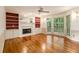 Spacious living room with hardwood floors, fireplace, built-in bookshelves, and large windows at 3420 Cranborne, Marietta, GA 30062