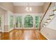 Bright foyer featuring hardwood floors, staircase with white risers, and large arched windows overlooking the backyard at 3420 Cranborne, Marietta, GA 30062