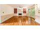 Spacious living room with hardwood floors, fireplace, built-in bookshelves, and large windows at 3420 Cranborne, Marietta, GA 30062