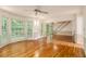 Open living room with hardwood floors, a ceiling fan, and a view of the foyer and the backyard at 3420 Cranborne, Marietta, GA 30062