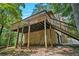 A rear view of this house showing a raised deck with wooden support beams and staircase access at 3611 Winfair Pl, Marietta, GA 30062