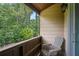 Private covered balcony with wooded view offers a peaceful retreat with convenient outdoor seating at 3611 Winfair Pl, Marietta, GA 30062