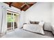 Bright bedroom showcases a vaulted, wood ceiling, neutral decor and access to a private balcony at 3611 Winfair Pl, Marietta, GA 30062