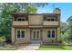 Charming two-story home featuring a covered entry and twin balconies with verdant lawn and mature tree surround at 3611 Winfair Pl, Marietta, GA 30062