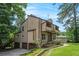 Exterior shot of a two-story home with a two-car garage and a beautifully landscaped yard at 3611 Winfair Pl, Marietta, GA 30062