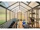 Bright greenhouse with metal raised garden bed, starter plants and wooden shelving for gardening at 3611 Winfair Pl, Marietta, GA 30062