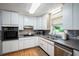 Efficient kitchen featuring white cabinets, updated appliances, and ample counter space at 3611 Winfair Pl, Marietta, GA 30062