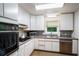 Efficient kitchen featuring white cabinets, updated appliances, and ample counter space at 3611 Winfair Pl, Marietta, GA 30062