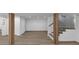 Finished basement featuring wood accent pillars, a light wood floor, a staircase, and an open floorplan at 851 Flagler Se Cir, Smyrna, GA 30080
