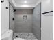 Modern bathroom features gray tile shower, river rock flooring, and stylish black fixtures at 851 Flagler Se Cir, Smyrna, GA 30080