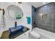 Stylish bathroom featuring a square vessel sink, a modern vanity, a round mirror, and a tiled shower and tub at 851 Flagler Se Cir, Smyrna, GA 30080
