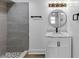 Modern bathroom boasts updated vanity, custom lighting, and a large shower with gray tile and river rock floor at 851 Flagler Se Cir, Smyrna, GA 30080