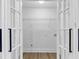 A walk-in closet features a rod and shelf for ample storage, as seen through glass doors at 851 Flagler Se Cir, Smyrna, GA 30080