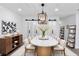 This gorgeous dining room features modern decor with an exquisite light fixture and barn doors at 851 Flagler Se Cir, Smyrna, GA 30080