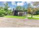 Modern ranch-style home with black exterior, bright orange front door, covered porch, and beautiful landscaping at 851 Flagler Se Cir, Smyrna, GA 30080