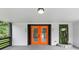 Welcoming front porch featuring bold orange double doors and a unique vertical garden feature, creating a stylish entrance at 851 Flagler Se Cir, Smyrna, GA 30080