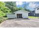 Detached garage with a black door, a modern design, and additional covered parking at 851 Flagler Se Cir, Smyrna, GA 30080