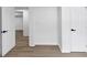 A hallway with modern floors and crisp white walls offers views into adjoining rooms at 851 Flagler Se Cir, Smyrna, GA 30080