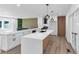 An updated kitchen features white cabinetry, an island, modern light fixtures, and stainless steel appliances at 851 Flagler Se Cir, Smyrna, GA 30080