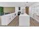 Modern white kitchen featuring white cabinetry, stainless steel appliances and a spacious island with pendant lighting at 851 Flagler Se Cir, Smyrna, GA 30080