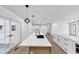 A kitchen island with a sink and stainless steel appliances is illuminated by modern pendant lights at 851 Flagler Se Cir, Smyrna, GA 30080