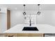 An undermount sink with a modern faucet featured in this kitchen island with modern cube pendant lights at 851 Flagler Se Cir, Smyrna, GA 30080