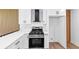 This modern kitchen features white cabinets, stainless steel appliances, and an over-the-range vent at 851 Flagler Se Cir, Smyrna, GA 30080