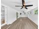 A bright living room with laminate flooring and fan lighting and a whitewashed brick accent wall at 851 Flagler Se Cir, Smyrna, GA 30080
