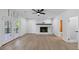 Bright open living room featuring white walls, hardwood flooring and a decorative white brick fireplace at 851 Flagler Se Cir, Smyrna, GA 30080