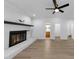 Bright and airy living room with white brick fireplace, hardwood floors, modern lighting and an open layout at 851 Flagler Se Cir, Smyrna, GA 30080
