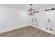 This large room has stunning barn doors, laminate flooring, and a modern hanging light fixture at 851 Flagler Se Cir, Smyrna, GA 30080