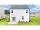 Backyard with patio, white siding, level lawn, and small garden at 12071 Conrad Cir, Hampton, GA 30228