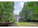 Exterior elevation of a two story home shows backyard with a deck, mature trees, and garden at 131 Banyon Ct, Dallas, GA 30157
