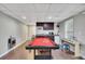 Basement rec room with pool table, kitchenette, and tile floors at 131 Banyon Ct, Dallas, GA 30157