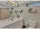 Well-lit bathroom featuring a toilet and single sink vanity at 131 Banyon Ct, Dallas, GA 30157