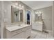 Bright bathroom with white double vanity and tile floor, plus a walk-in closet at 131 Banyon Ct, Dallas, GA 30157