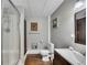 Bathroom features a stall shower, white toilet and vanity sink with a dark wood cabinets at 131 Banyon Ct, Dallas, GA 30157