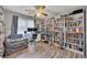 Bedroom featuring hardwood floors, ceiling fan, many bookshelves, and window at 131 Banyon Ct, Dallas, GA 30157