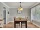 Cozy dining room with wood floors, modern chandelier, and natural light at 131 Banyon Ct, Dallas, GA 30157