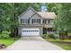 Traditional two-story home with a two-car garage, mature trees and an inviting front porch at 131 Banyon Ct, Dallas, GA 30157