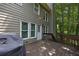 Exterior deck space with a grill and views of the tree lined backyard at 131 Banyon Ct, Dallas, GA 30157