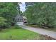 Well-maintained home surrounded by lush, mature trees and a spacious front yard at 131 Banyon Ct, Dallas, GA 30157