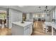 Modern kitchen with a large island, light countertops, and views into a living room at 131 Banyon Ct, Dallas, GA 30157