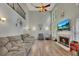 Open living room featuring wood floors, a cozy fireplace, and an entertainment center at 131 Banyon Ct, Dallas, GA 30157