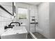 Bathroom featuring black fixtures, white subway tile, glass shower doors, and a vessel sink at 2240 Cheshire Bridge Ne Rd # 206, Atlanta, GA 30324
